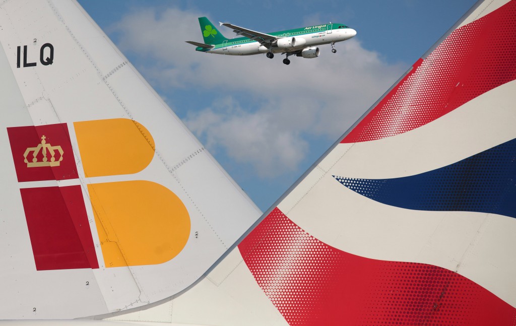 British Airways and Iberia Airways are due to complete a merger during 2010. Image shows the tailfins of a British Airways plane and an Iberia plane parked besides eachoter.